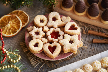 Selection of homemade Christmas pastry - Linzer cookies, coconut balls and wasp nests or beehives