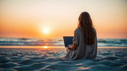 Fototapeta premium A woman is sitting on the beach and working remotely on her laptop
