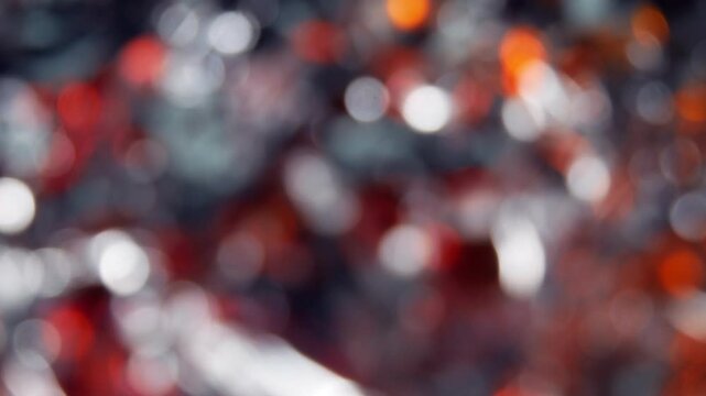 Silver metal background with red flashes. The texture of a blurred and abstract background with a side.
