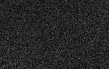 A close-up of a black textured surface, showcasing detailed patterns and uniform color, perfect for backgrounds.