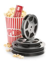 Tasty popcorn, film reels and movie ticket isolated on white