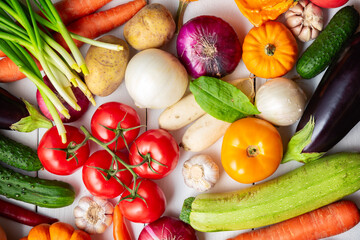 Organic fresh vegetables food background. Autumn vegetables and Thanksgiving day theme. Pumpkin, onions, carrots, tomatoes, mushrooms, cucumbers and other.