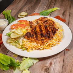 Grilled Chicken over Biryani Rice with Fresh Vegetables and Sauce

