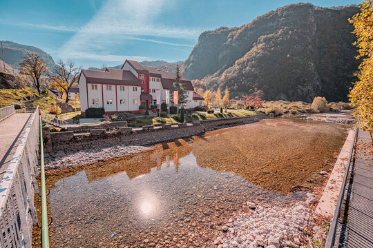 1 November 2024, Savnik, Montenegro: Municipal administration office building reflecting on the shallow waters of Bukovica river, during a sunny autumn day