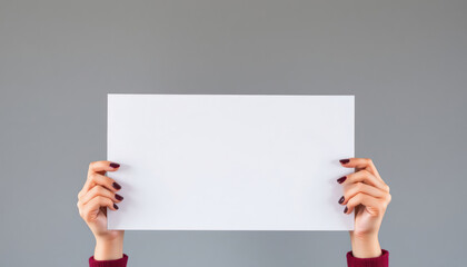 Fototapeta premium Woman holds blank sign. Empty poster presented. Modern design. Simple image. Presentation concept. Marketing idea. Empty space for text. Advertising concept. Template. Blank card. Hands hold blank