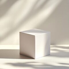 Minimalist white cube on light background with shadows.