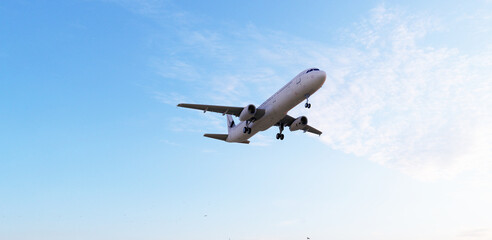 ULTRA HD. Airplane flies in blue sky. Travel, tourism. Airplane takes off against the background of blue sky.  