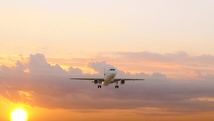 ULTRA HD. Airplane flies in sunset sky. Travel. Airplane takes off against the background of sunset sky.	
