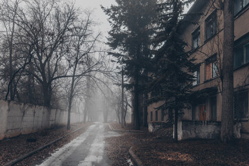 Fototapeta premium Old foggy city street, abandoned hospital