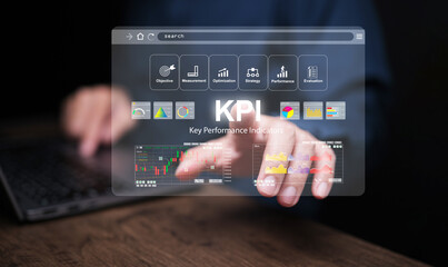 KPI key performance indicator. A businessman with computer notebook tapping on virtual screen to use KPIs to measure progress of his business, project, or work over time to reach the goals