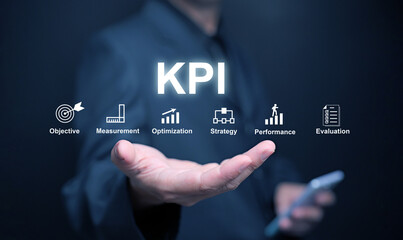 KPI key performance indicator. A businessman, in his hand, uses KPIs to measure progress of his business, project, or work over time to reach the goals