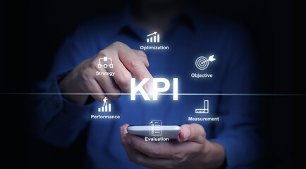 KPI key performance indicator. A businessman with a smartphone uses KPIs to measure progress of his business, project, or work over time to reach the goals