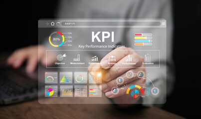 KPI key performance indicator. A businessman with a stylus tapping on virtual screen to use KPIs to...