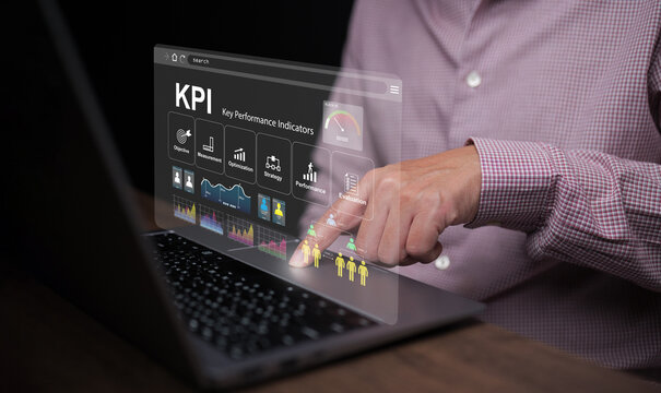KPI key performance indicator. A businessman with a notebook computer uses KPIs to measure progress of his business, project, or work over time to reach the goals