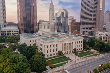 High-angle view of the Ohio Statehouse in Columbus, Ohio. Flags line the lawn, showcasing the city's civic pride. OHIO STATEHOUSE, COLUMBUS, OHIO, UNITED STATES