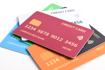 Pile of multicolored credit cards isolated on white background