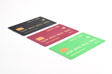Three credit cards with chip on white background. Green, red, black credit cards