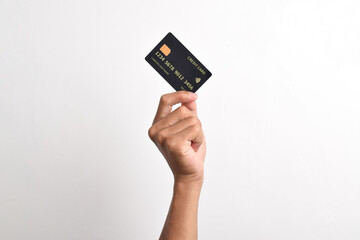Close up of hand with black credit card isolated on white background. Shopping, finance and people concept