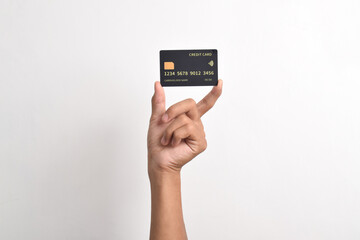 Close up of hand with black credit card isolated on white background. Shopping, finance and people concept