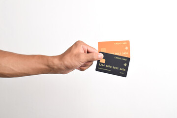 Hand is hold two credit cards. Black and orange credit cards isolated on white background.