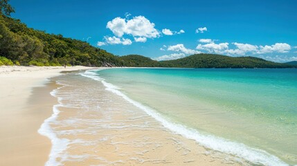 Serene Tropical Beach with Clear Water and Lush Green Landscape