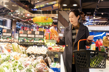 Woman Shopping for Fresh Produce in a Modern Grocery Store