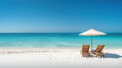 Fototapeta premium Tropical beach vacation with two beach chairs and umbrella.
