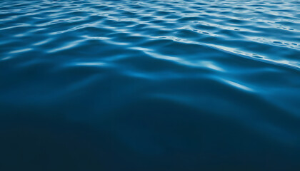 Dark blue abstract background. Reflection of light on a smooth surface of water with small waves.