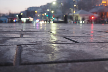 Wet Pavement at Dusk Capturing the Beautiful City Lights Reflection
