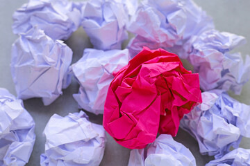 Clumped paper balls on grey background.