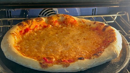 homemade pizza still baking in oven