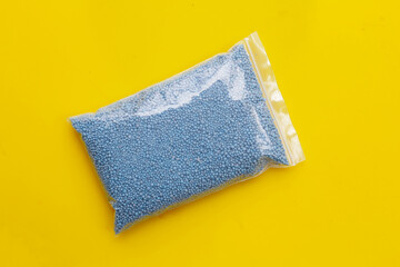 Chemical fertilizer on yellow background.
