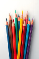 A group of colorful pencils and crayons isolated on a white background, perfect for drawing and school activities