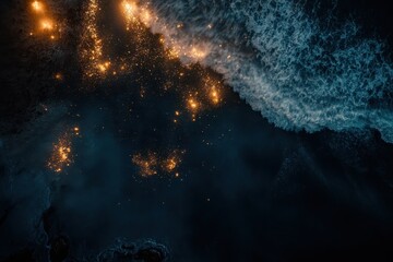 Obraz premium Abstract Aerial View of Ocean Waves and Golden Sparkles at Night Dramatic Coastal Scene