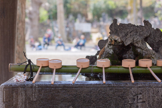 traditional ladles at the purification fountain chozuya in hokkekyo temple in ichikawa city
