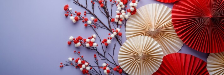 Stylish and clean arrangement of red and cream paper fans with a floral touch on a purple background, perfect for decoration and celebration themes.