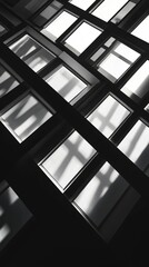 Abstract view of modern architecture showcasing geometric patterns and light reflections on glass windows.