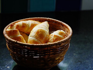 Freshly baked french croissants in a wicker bowl