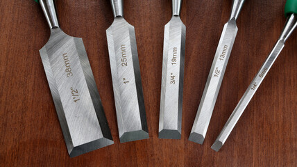Set of woodworking chisels on wooden surface