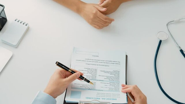 Patient attend doctor's appointment at clinic or hospital office, discussing medical treatment options and explaining examination results or medical record about sickness. Slow motion. Rigid.