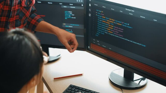 Slow motion back end or software developer manager supervising his team on new application program development on debugging and solving complex code algorithms on monitor. Burgeoning