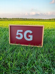 Red Signboard Displaying 5G Network Symbol in Lush Green Field