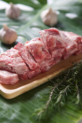 raw pork ribs on a wooden plate