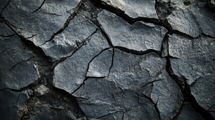 Dark grunge texture with cracked surface and subtle charcoal gray tones