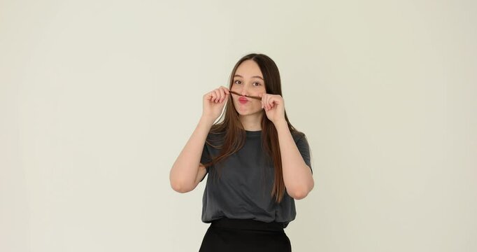 Young woman shows off her moustache with hair