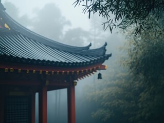 Misty morning view of a traditional Asian temple roof and bamboo forest.