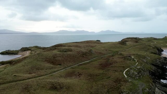 Aerial view over Ynys Llanddwyn island idyllic landscape with Snowdonia mountains skyline