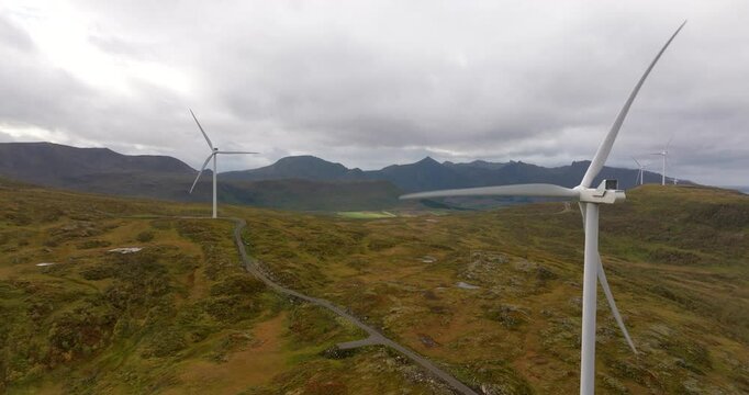 Drone view of rotating wind turbines in alpine landscape of Sortland, Norway