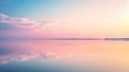 A peaceful scene of a pastel-colored sunset reflecting on a calm lake, with soft clouds in a tranquil sky.