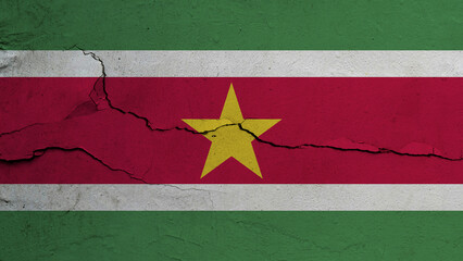 Suriname flag on cracked wall background, flag with crack line